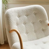 White and green lounge chair with boucle sherpa upholstery and solid wood armrests